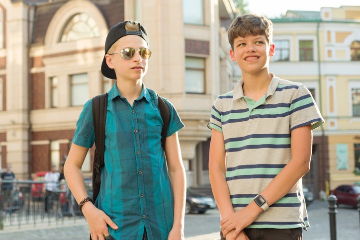 Image of 2 14 year old boys hanging out outside smiling for the camera