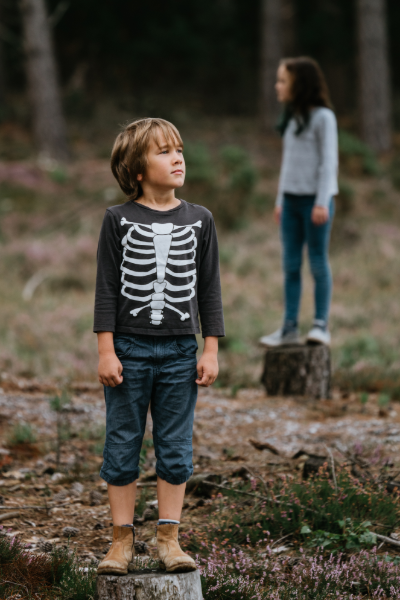 Image of a 10 Year Old Boy Standing outside wearing a shirt with a rib cage skeleton on it