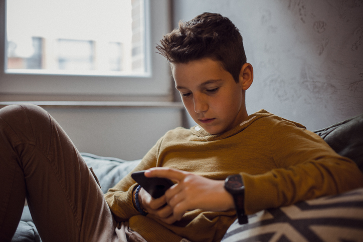 image of 12 year old boy Relaxing in his Bedroom