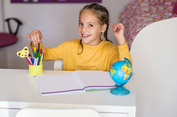 Image of a 9 Year Old Girl Studying At A Desk